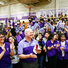 Teacher holding trophy